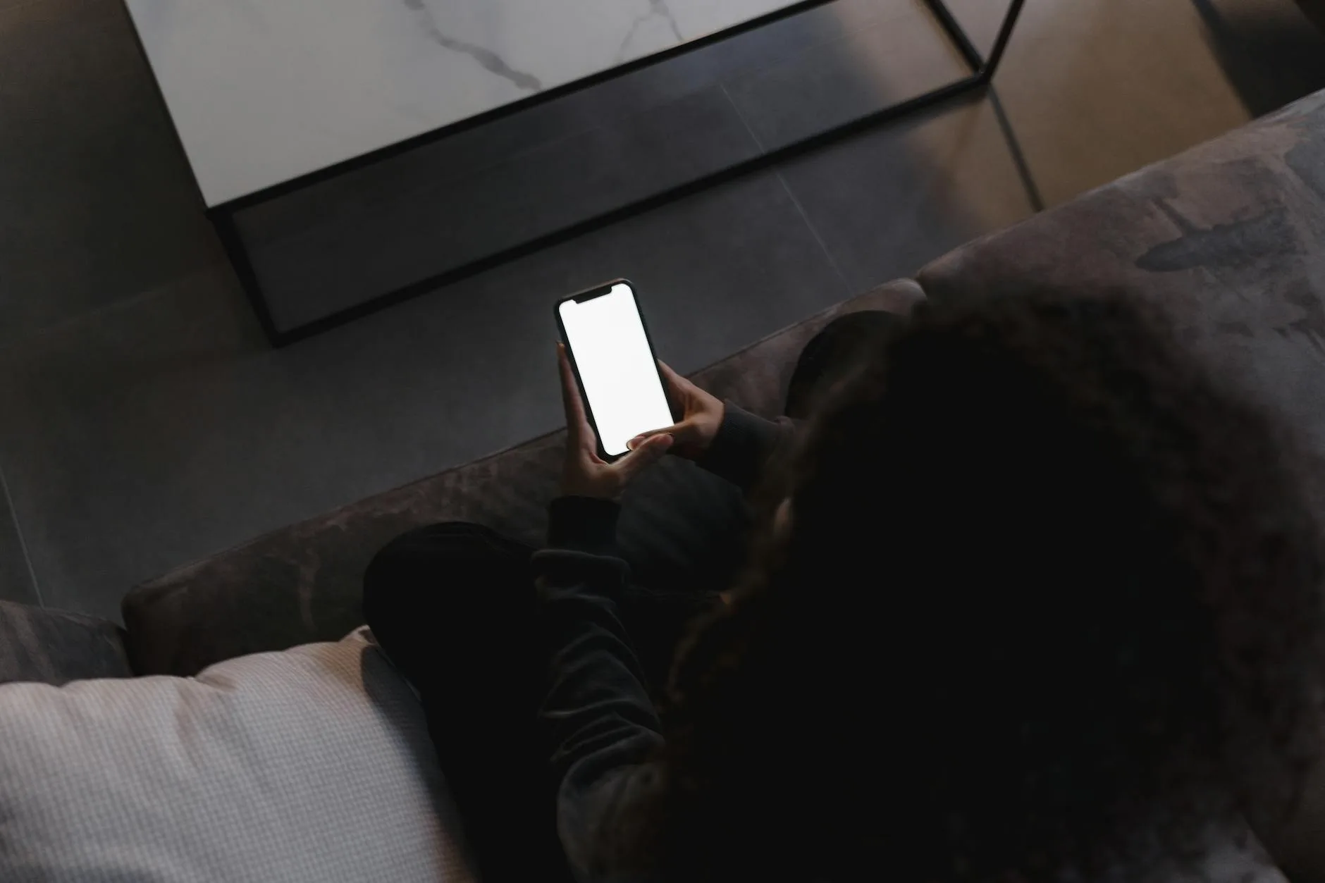 Person checking security camera app on smartphone at home