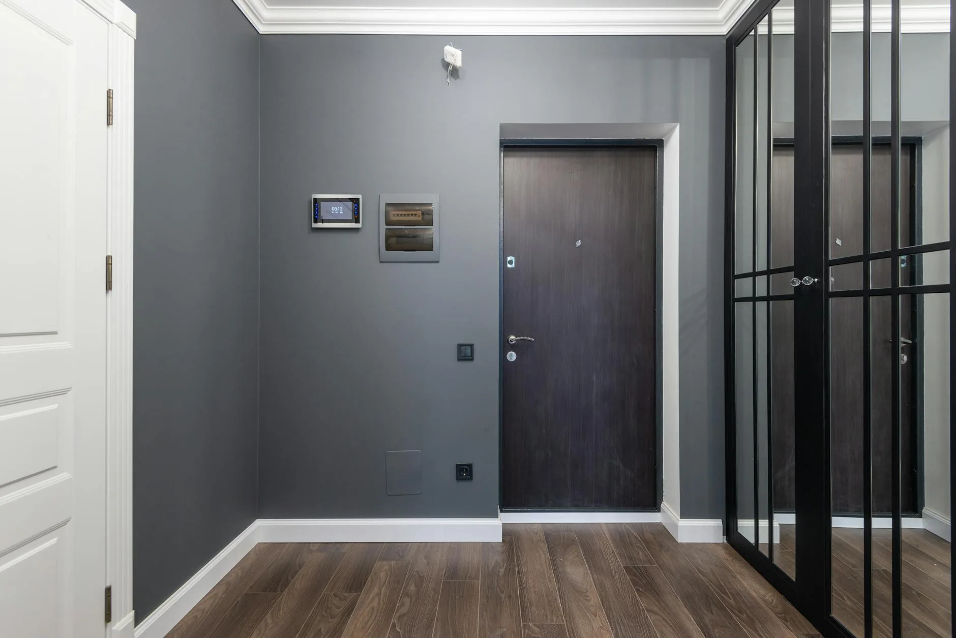 Close-up of a wireless door sensor fitted to a white door frame