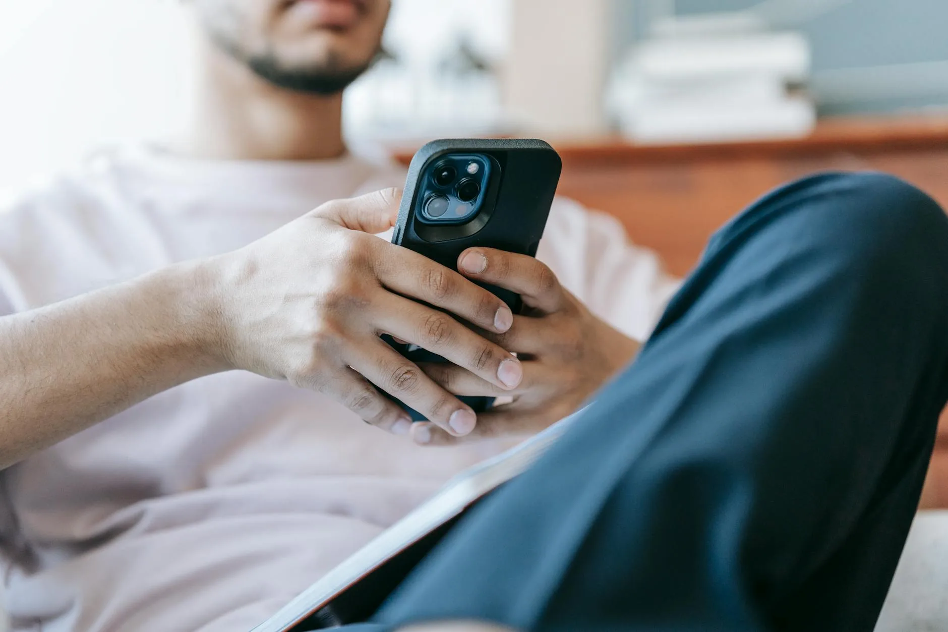 Person using a phone app to control home heating remotely