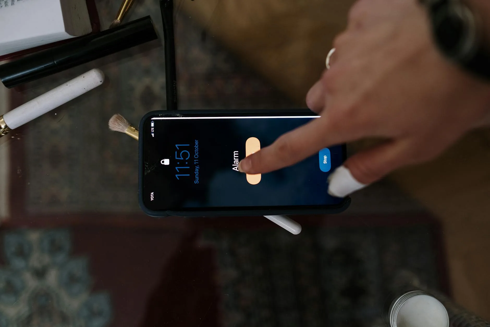 Person checking smart alarm app notification on smartphone