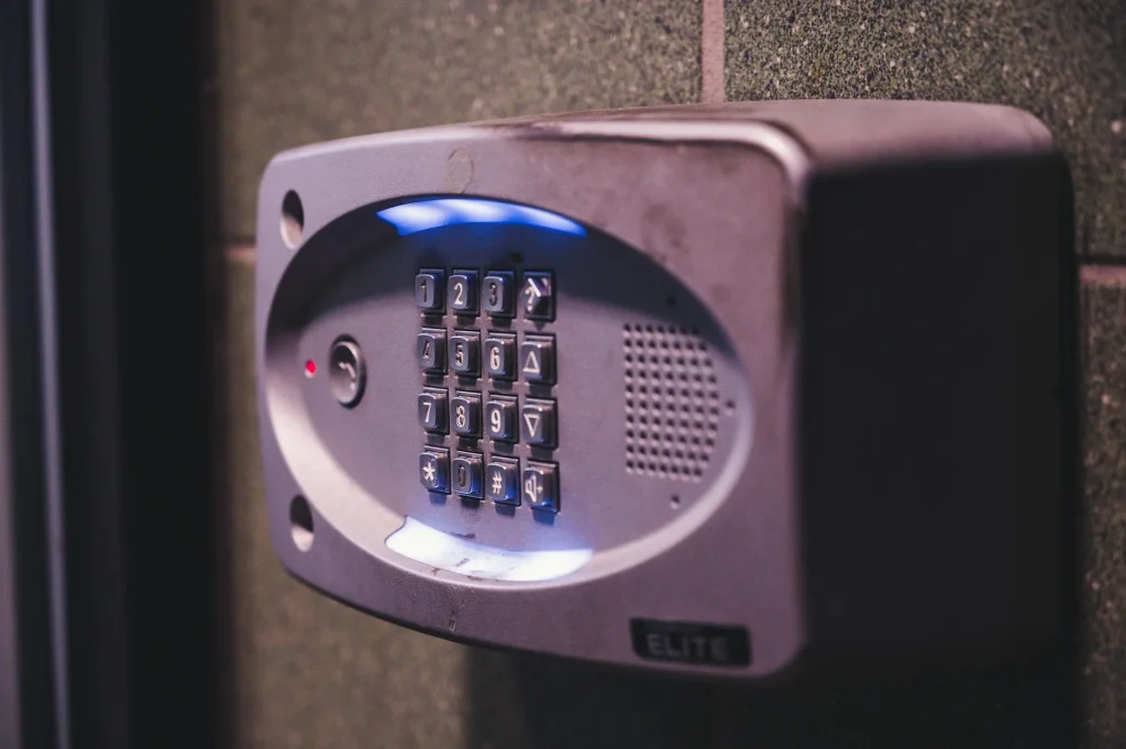 Smart home alarm keypad mounted on a wall near the front door