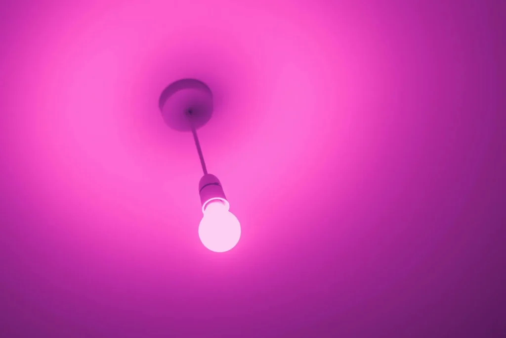 Colour-changing smart bulb glowing pink — Zigbee Z-Wave Wi-Fi smart lighting